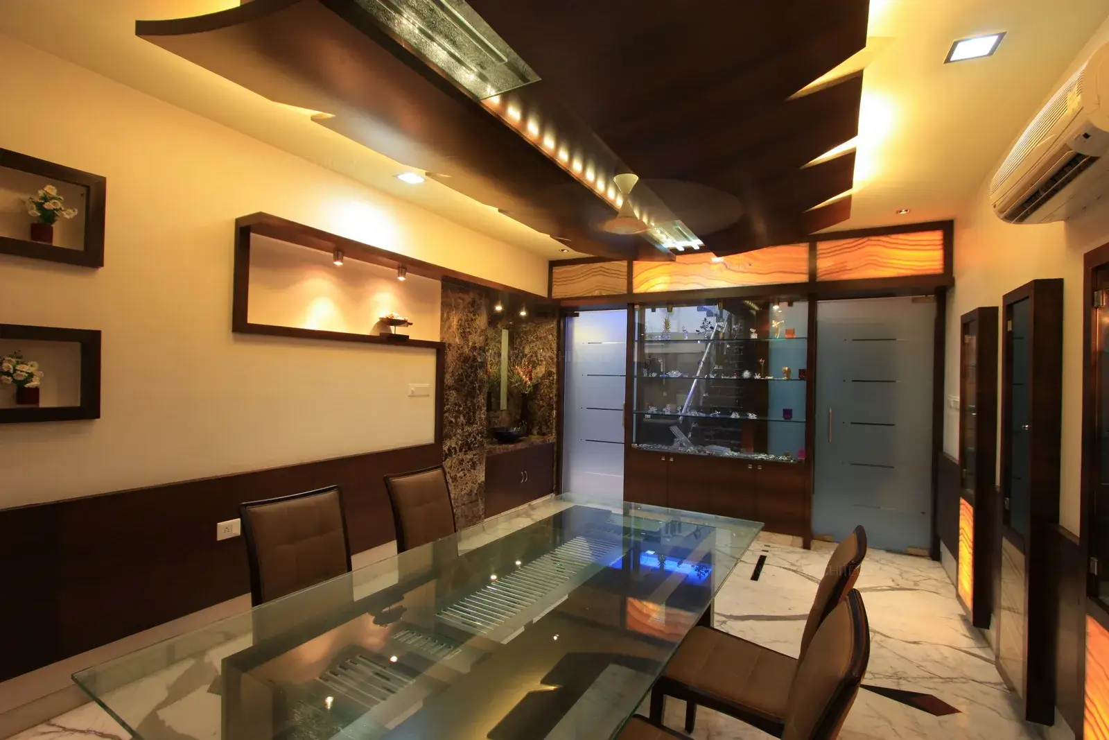 The formal dining area has been designed with rich wooden panelling and onyx marble for a royal look.