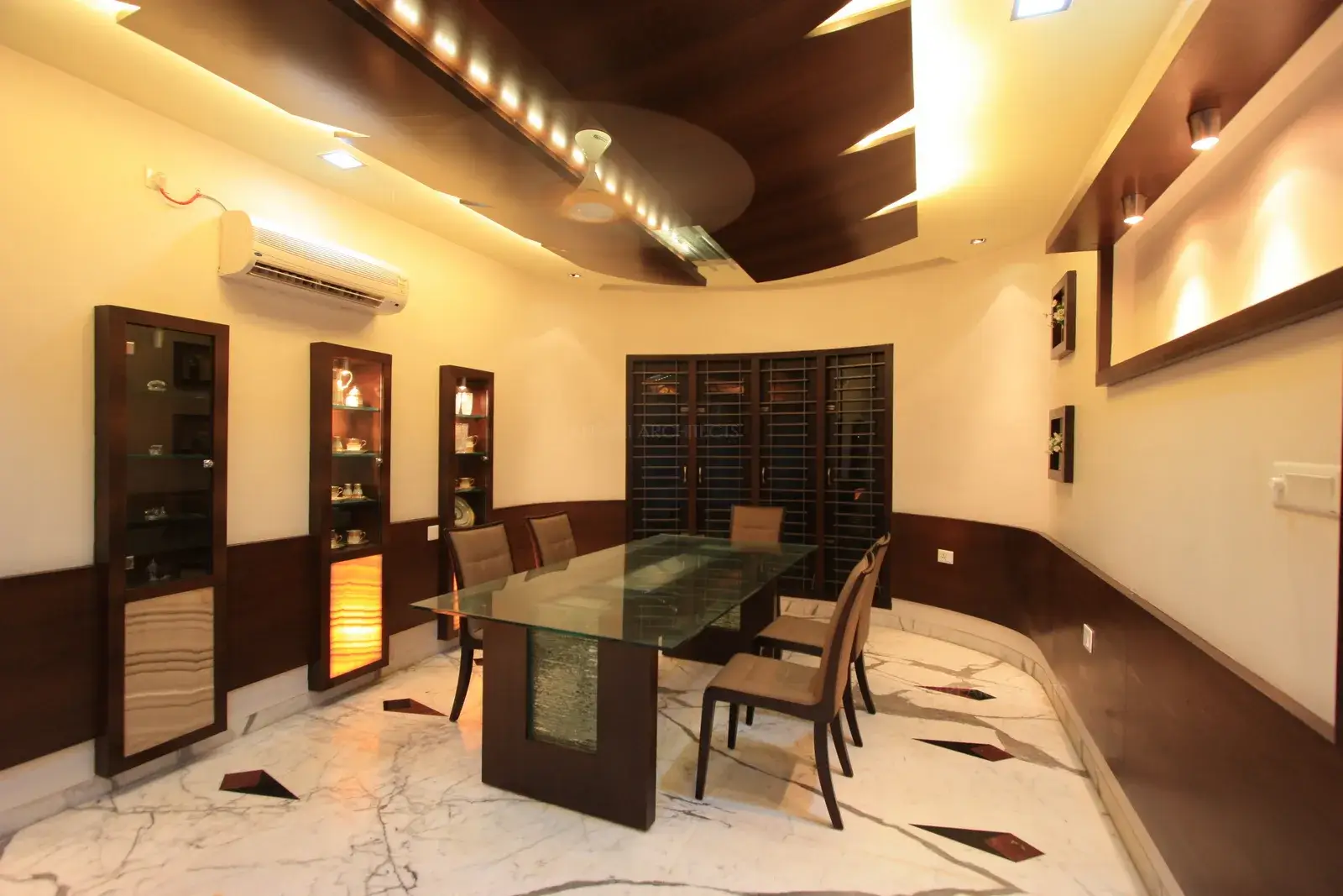 Sleek and contemporary covered shelves have been designed within the wall which acts as a perfect display for their fine crockeries.