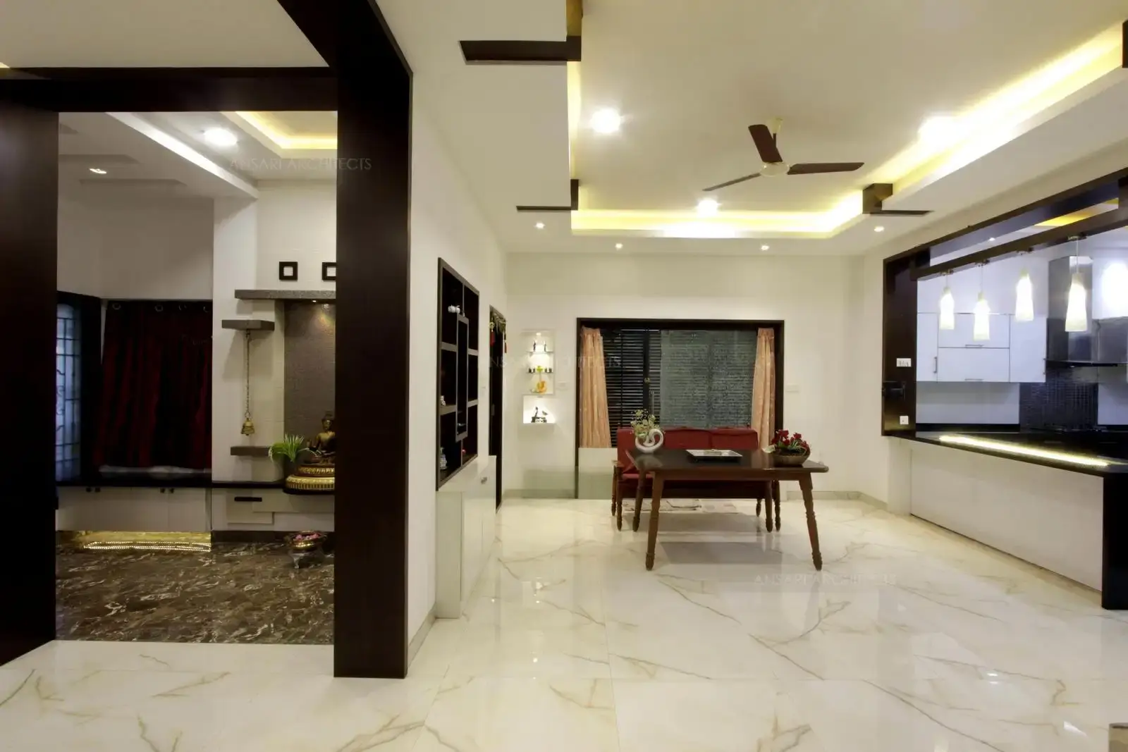 Lobby area looks simple, with formal seatings and wooden table the ceiling is highlighted with strip lights and recessed ceiling makes a perfect space.