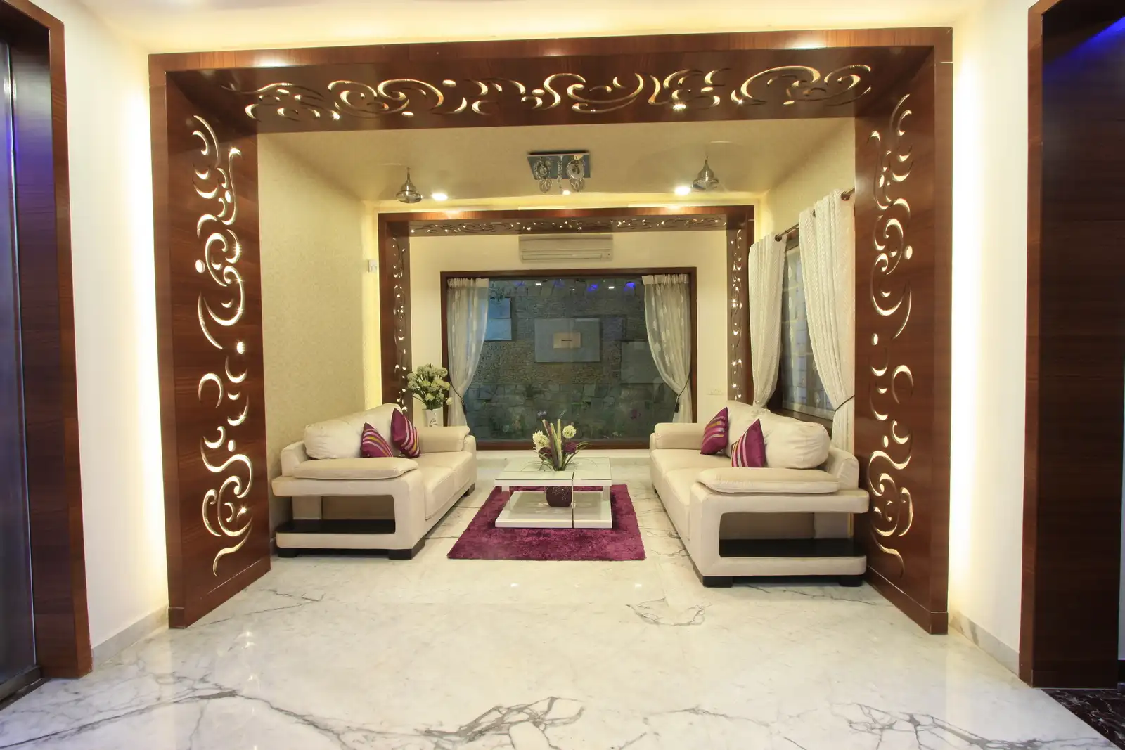 View of drawing room in the ground floor showing the intricate cut out panel, courtyard and simple sofas which compliment the whole decor of the room.