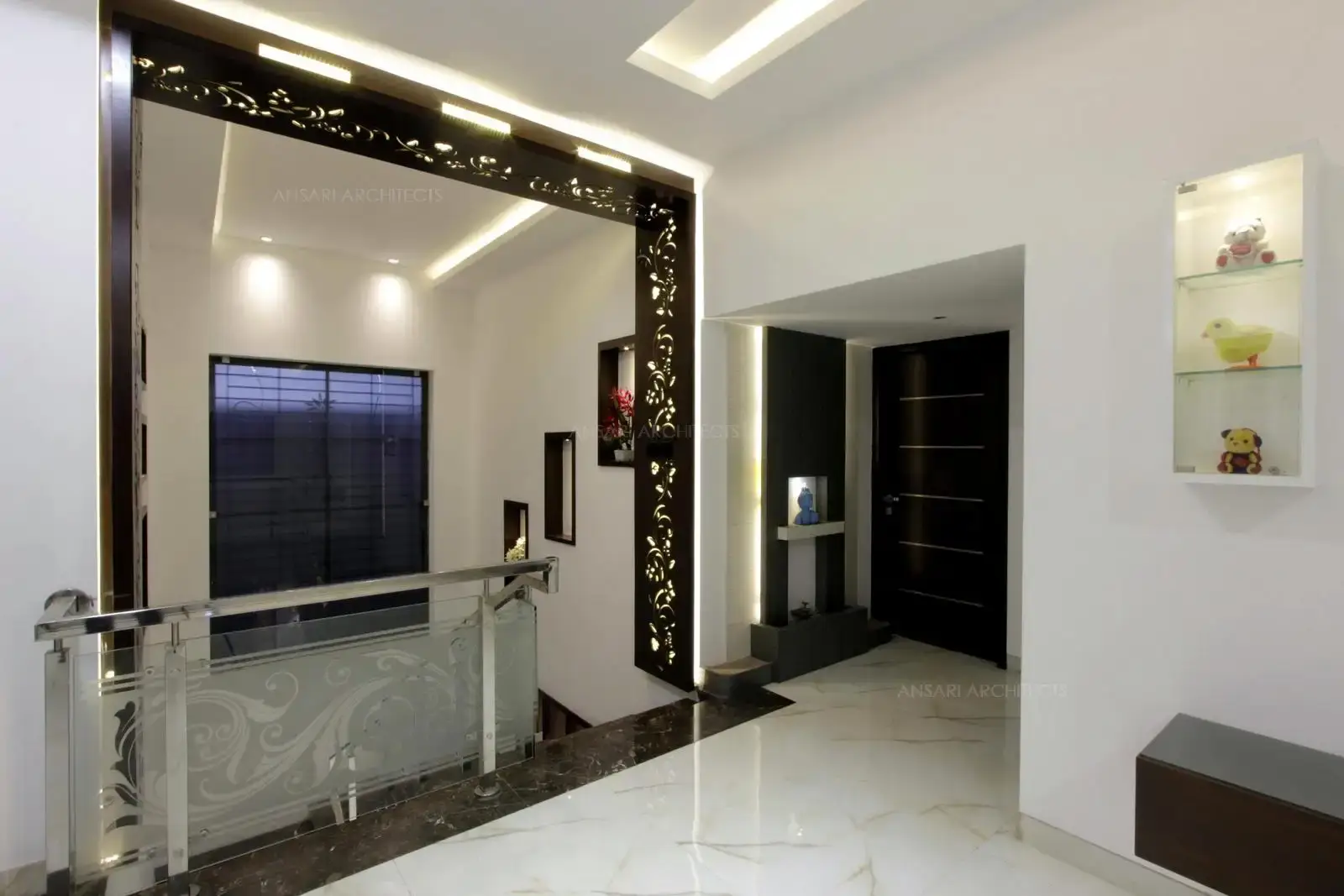 Rich dark toned panel finish creates a visual interest and depth at this level with designed pattern from wall to ceiling with soft glow of lights, accents for focal elements with gold toned effects gains in a prominent decorative element.