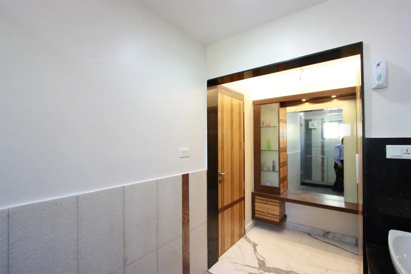 Wall tiles with highlighters are coordinated with veneer colours in the dressing area.