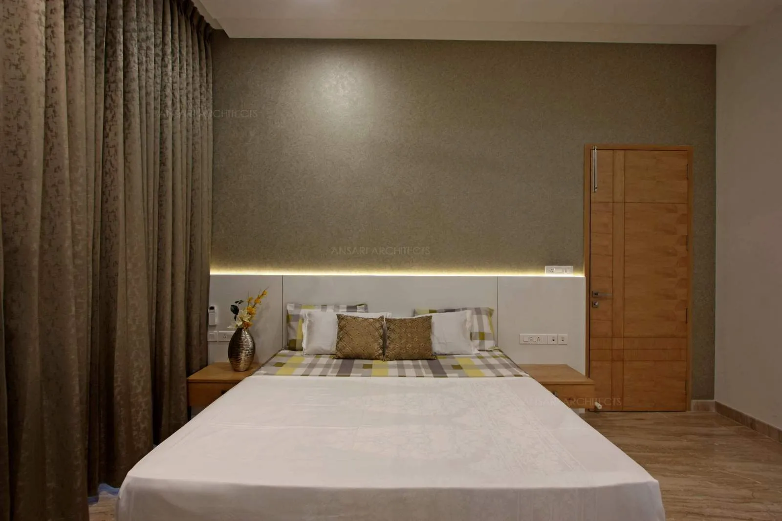 Moss coloured texture wallpaper with backlit headborad in white looks simple and elegant, ample lighting and soft wood texture for the solid door enhances comfort.