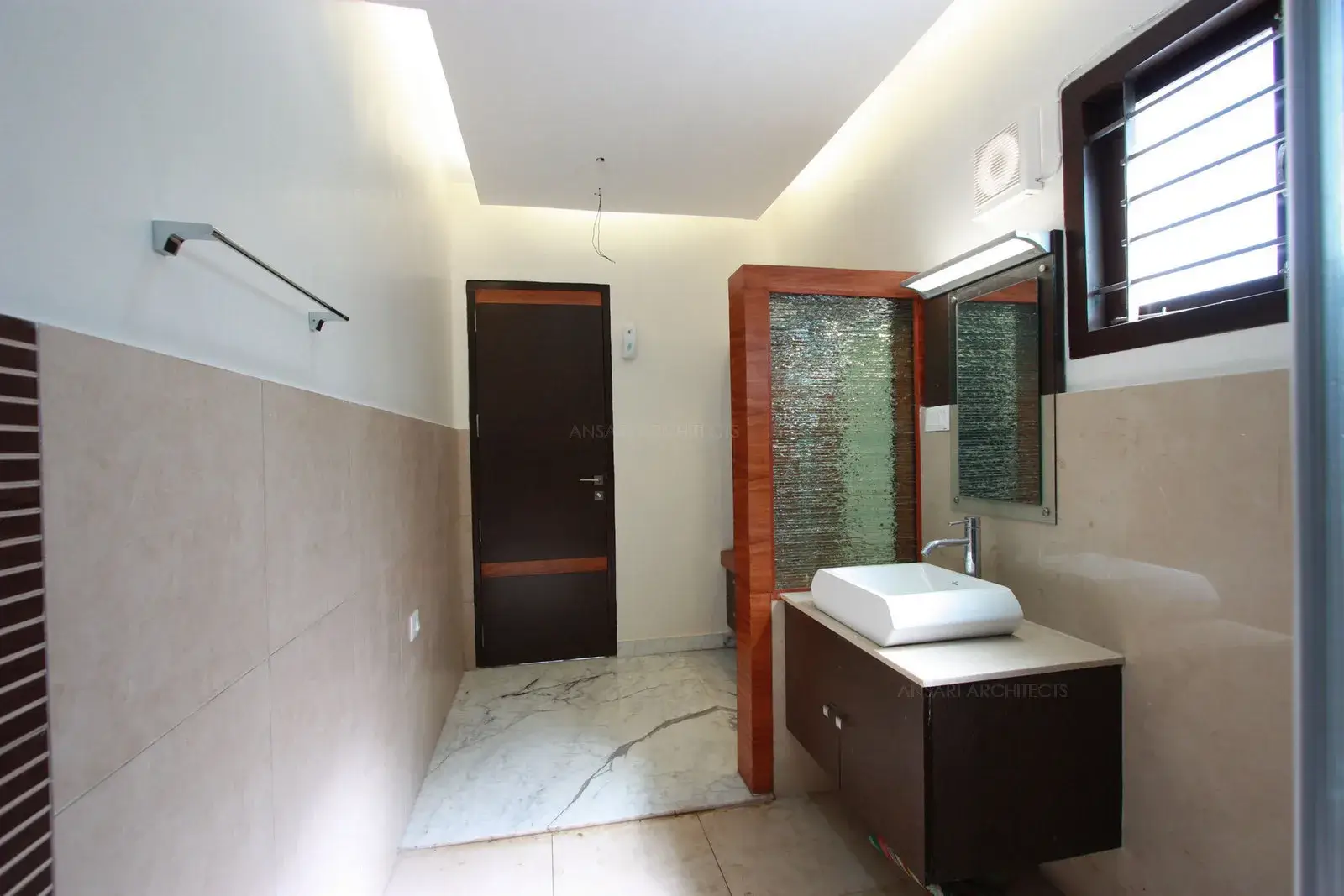 Bright and larger size of wall tiles are used with simple highlighters in this toilet of bedroom-3.