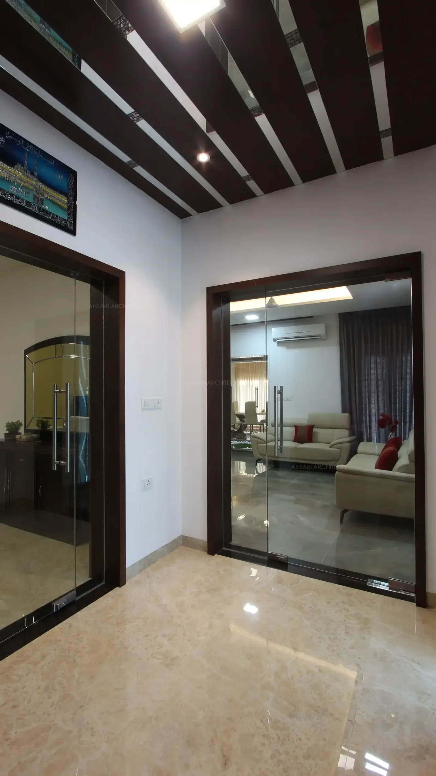 The glass doors achieves the visual connectivity towards the spaces, leading to the living and gents hall.