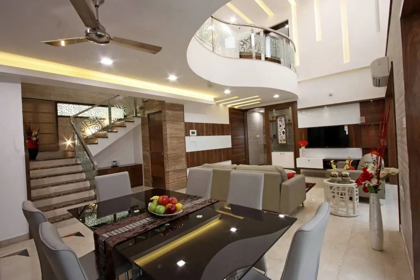 The double height living providing an illusion of additional space. The play of different surfaces and textures create a sense of contrast . All of the elements seamlessly blend to give the living area a holistic modern appeal.