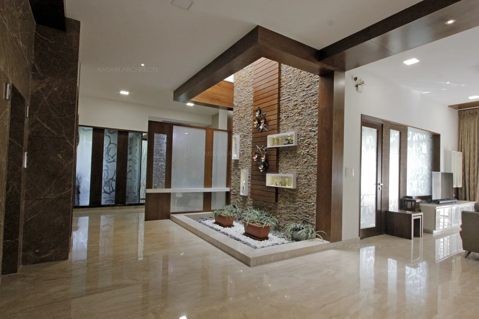 Courtyard here is open, connective, airy and bathes the space with natural light. The wooden beading highlights the entire area.