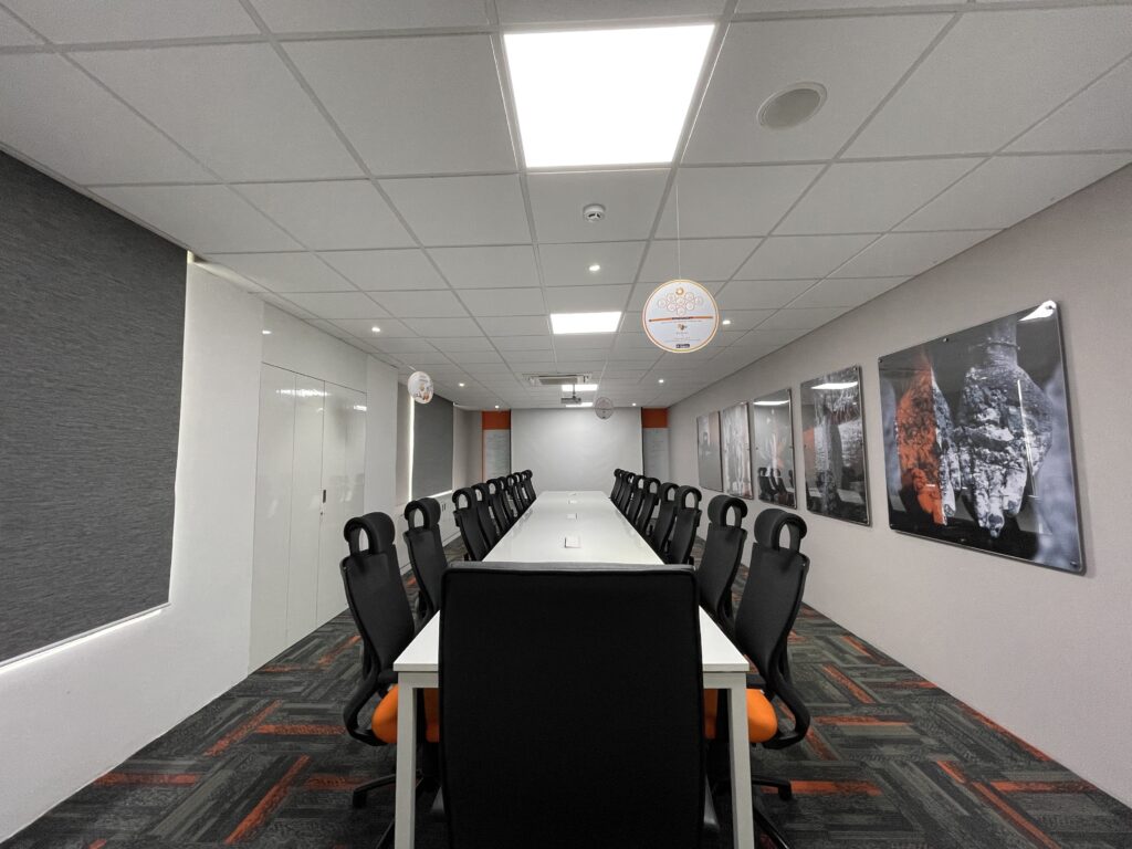 a long conference room with chairs and a table